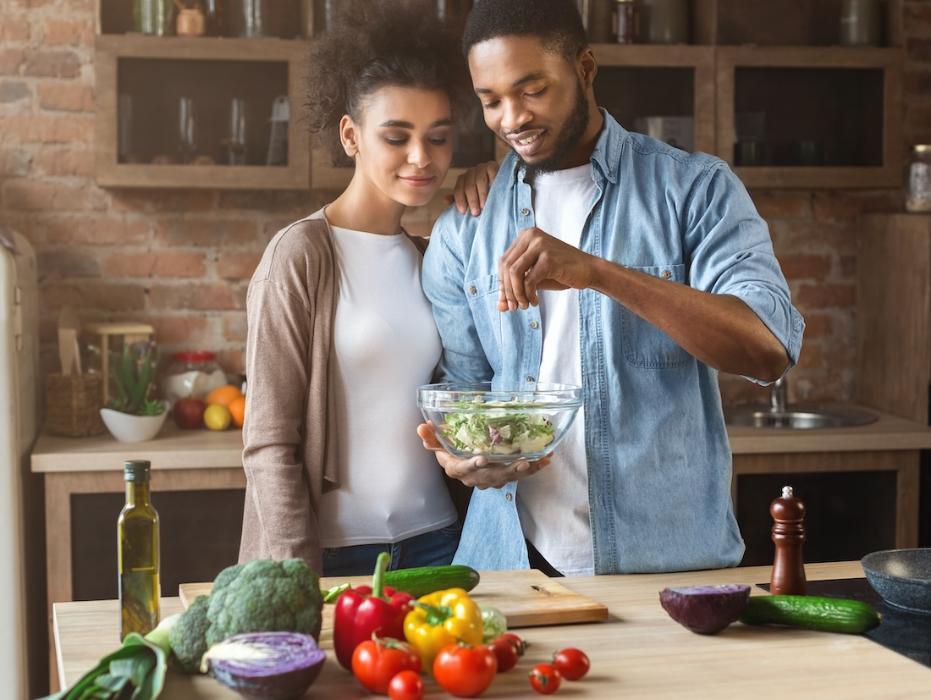 young couple making a salad in maple grove