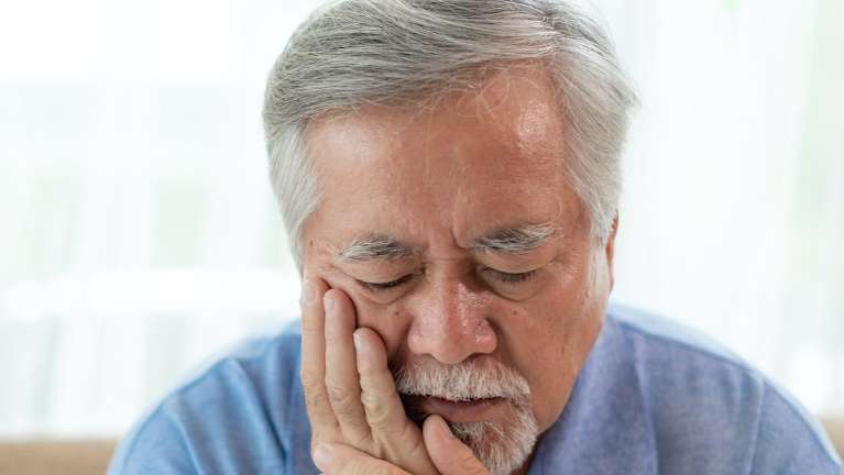 man with a toothache in maple grove