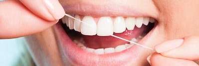 girl flossing her teeth in maple grove mn